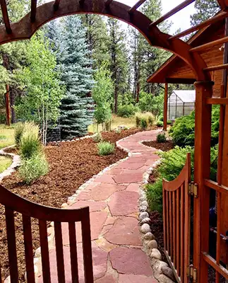 flagstone path with mulched flower beds
